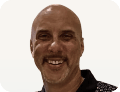 Ben Katt, a spiritual coach and meditation teacher, smiling warmly to inspire mindfulness and inner peace.