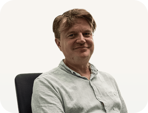 Portrait of Ben Katt, a spiritual coach and meditation teacher, smiling confidently in a professional setting, promoting mindfulness and inner peace.